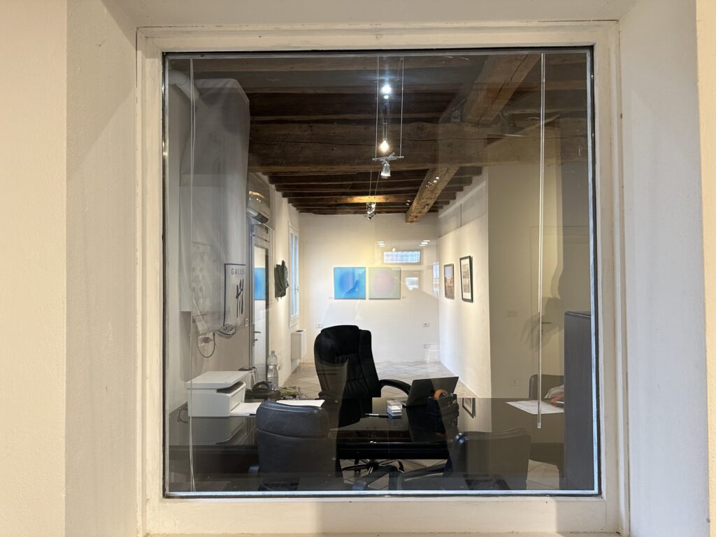 The Stefania Carrozzini Gallery on the Giudecca, seen through its window, with two Blue Pearl paintings on the far wall