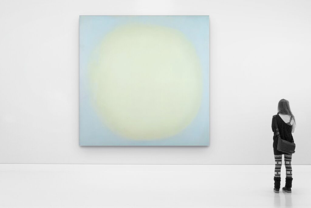 Blue Pearl No. 10 shown large in a white gallery, with a visitor looking at it